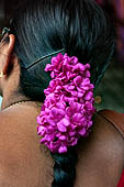 Scented garlands of fresh flowers swaying in women black hair near the Swamimalai temple. 